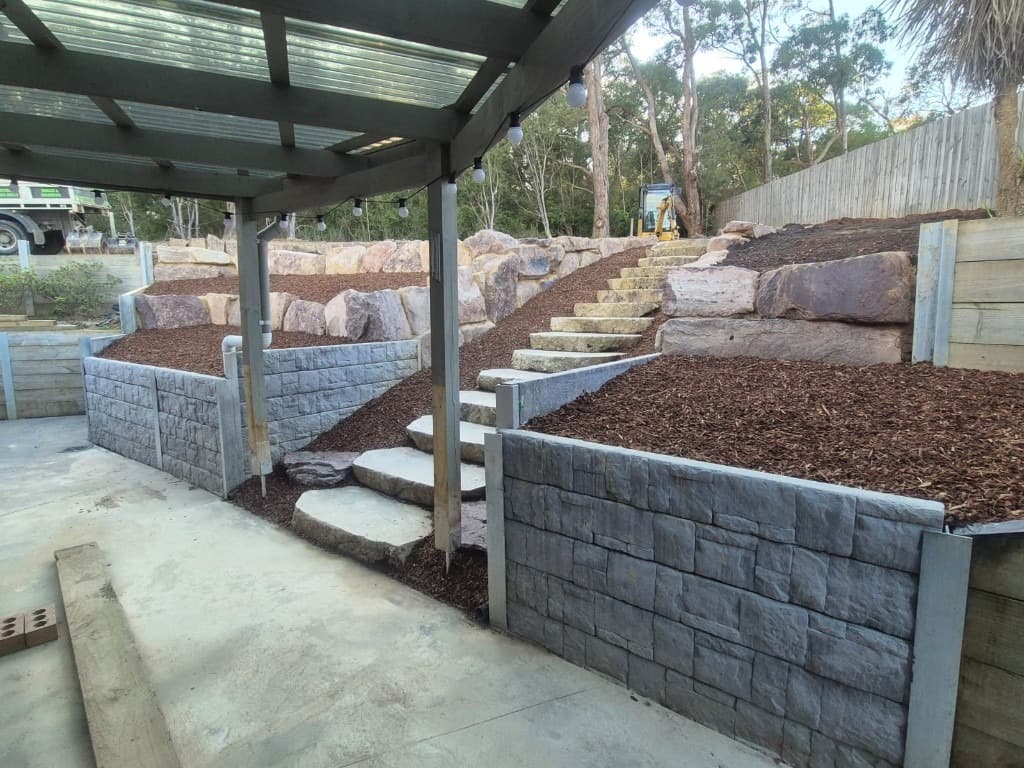 Natural stone stairs with tiered retaining walls
